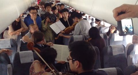 Orchestra_musicians_perform_on_flight.jpg