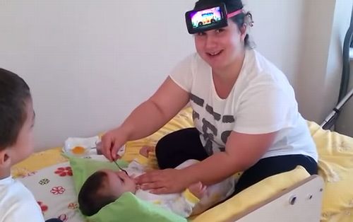 Feeding_Baby_with_Phone_on_head.jpg