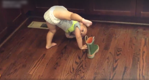 Baby_Hilariously_Struggles_to_Put_on_Boot.png